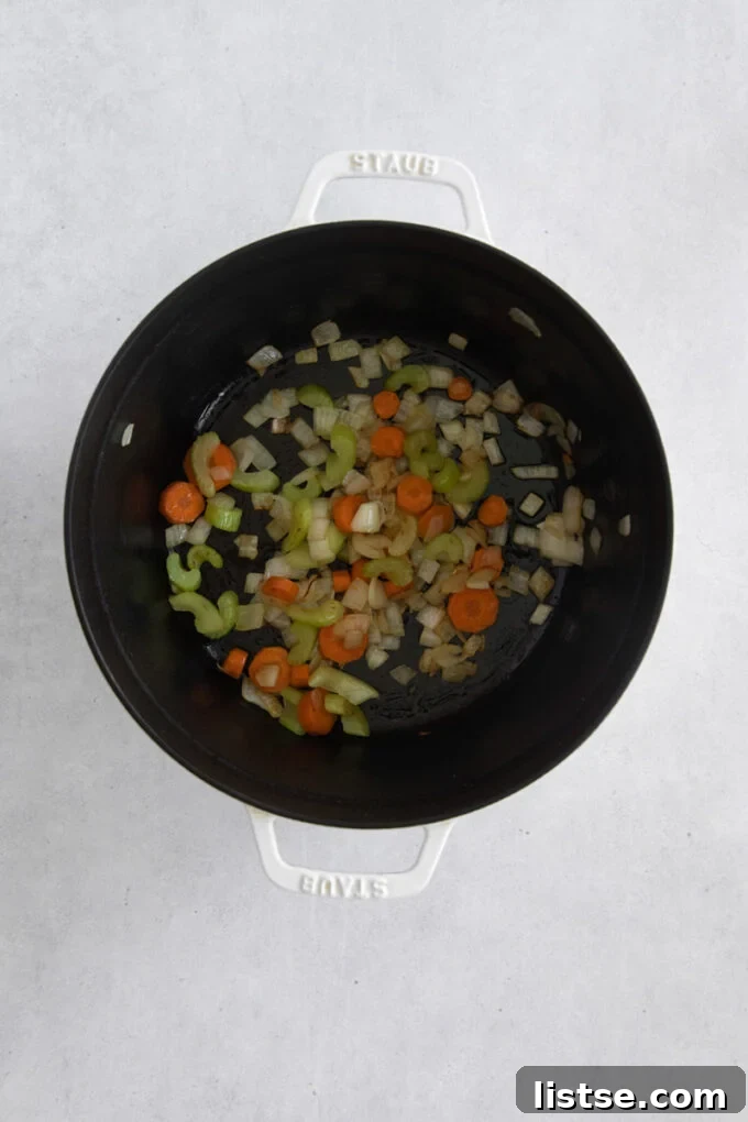Velvety Vegan Broccoli Goodness 5 Sautéing onion, carrot and celery in a large pot for vegan broccoli soup