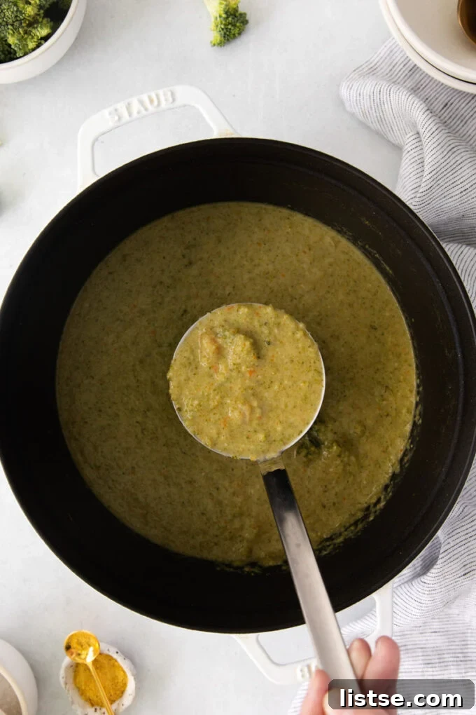Velvety Vegan Broccoli Goodness 8 Using a ladle to serve creamy vegan broccoli soup into a bowl