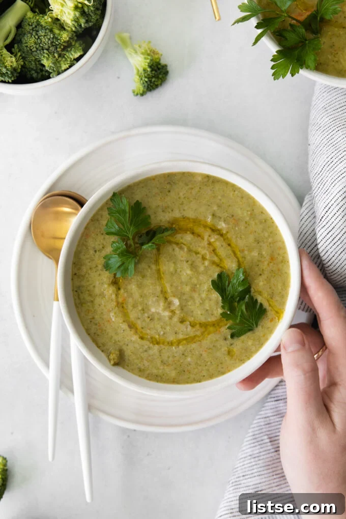 Velvety Vegan Broccoli Goodness 9 Vegan broccoli soup in a white bowl drizzled with olive oil and topped with fresh parsley