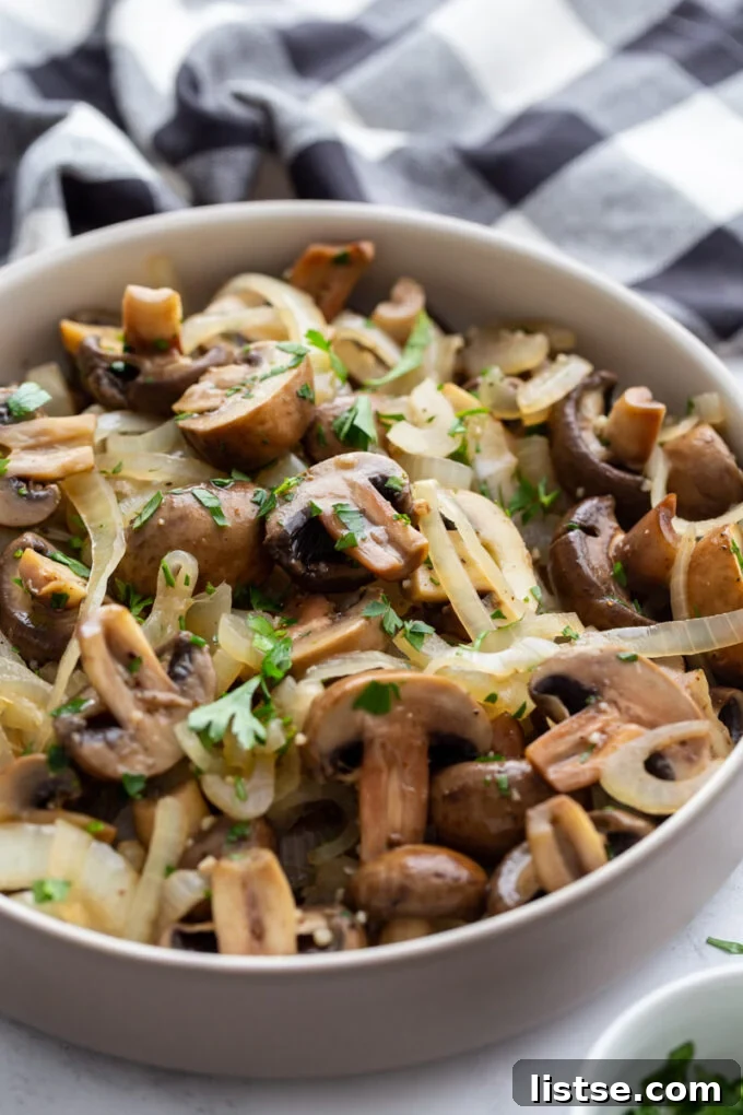 Close-up of a bowl of Sautéed Mushrooms and Onions, beautifully garnished with chopped parsley
