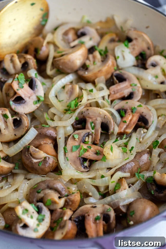 Detailed shot of Sautéed Mushrooms and Onions, freshly sprinkled with parsley, showcasing their rich color and texture