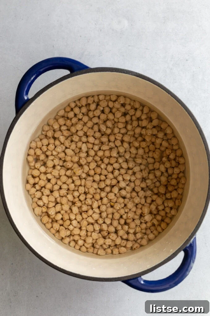 Large pot filled with chickpeas covered in water on the stovetop