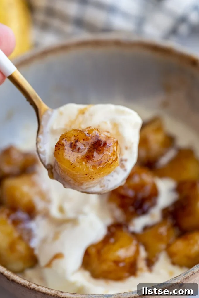 Molten Caramel Bananas 6 A spoonful of vanilla ice cream with a caramelized banana slice on top.