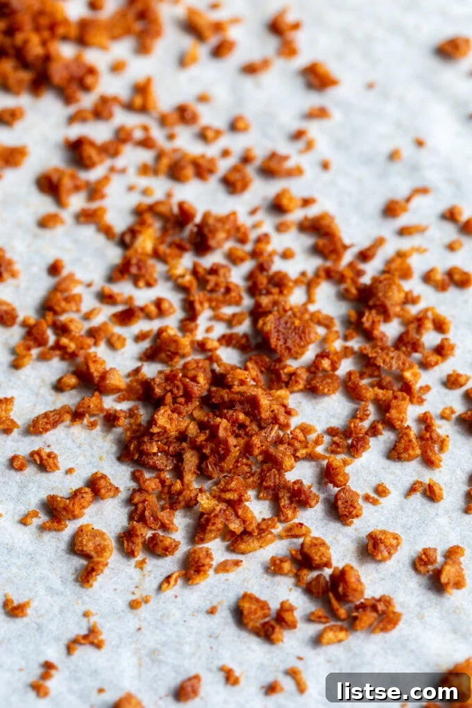 A vibrant close-up of finished vegan bacon bits, perfectly seasoned and crispy, ready to be enjoyed