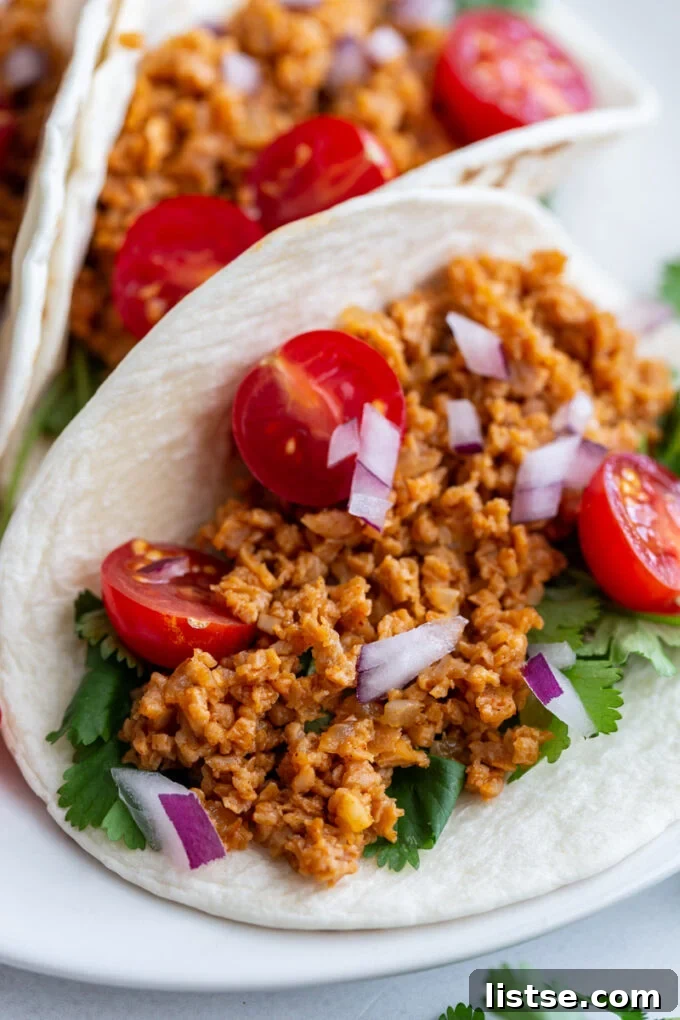 Unlocking TVP: A Comprehensive Guide to Versatile Plant-Based Meals and Perfect Tacos 5 A close-up of a soft taco shell generously filled with seasoned TVP taco meat and an assortment of fresh, colorful vegetables