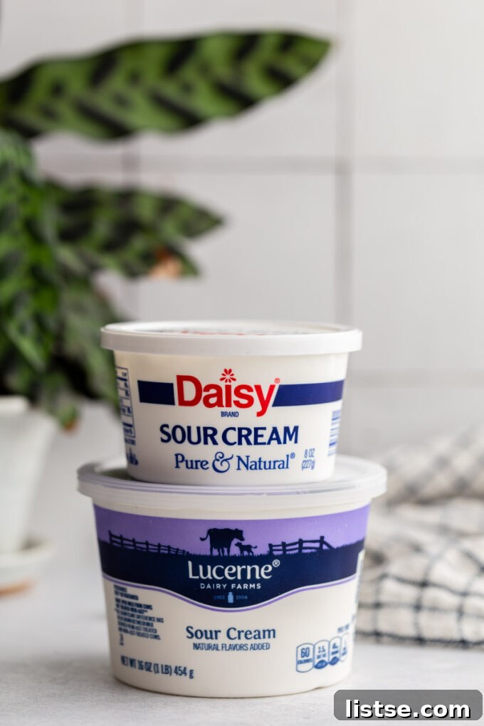 Two tubs of sour cream stacked on top of each other, suggesting abundance and the need for storage solutions.