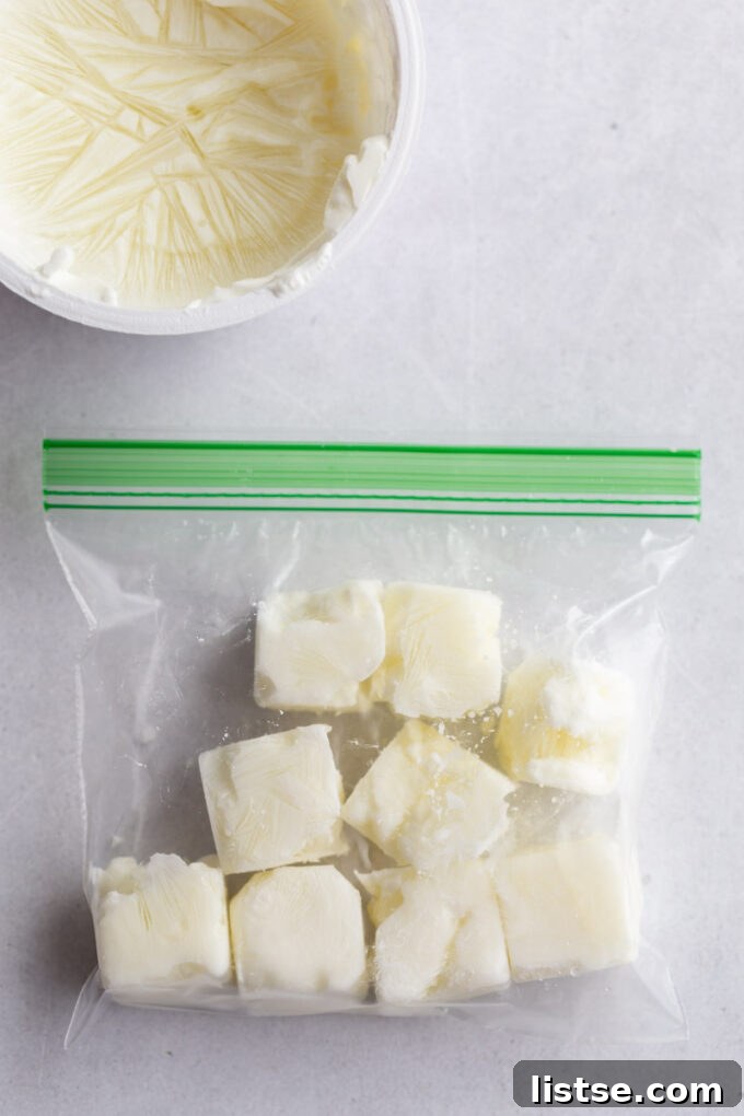 Frozen sour cream cubes stored in a resealable bag, ready for long-term storage and easy access.