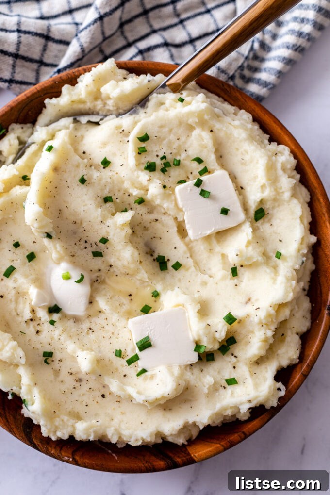 Effortless Vegetarian Crockpot Feasts 20 Creamy slow cooker mashed potatoes, topped with pats of melting butter.