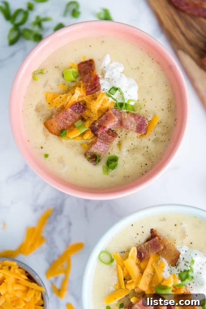 Effortless Vegetarian Crockpot Feasts 3 Creamy potato soup garnished with fresh herbs, ready to be served from a bowl.