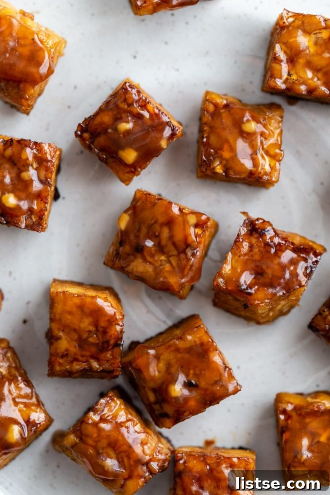 close up shot of baked tempeh covered in a teriyaki sauce
