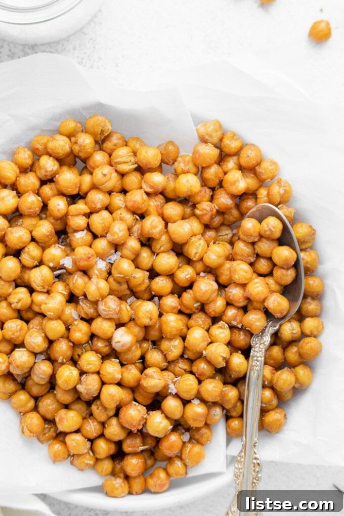 A bowl filled with perfectly air-fried crispy chickpeas, seasoned and ready for snacking or adding to dishes.