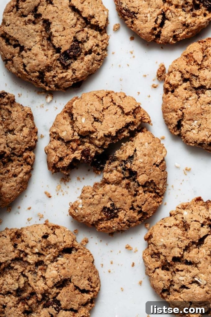 Cross-section of a thick, chewy vegan oatmeal cookie revealing its wholesome texture and ingredients.