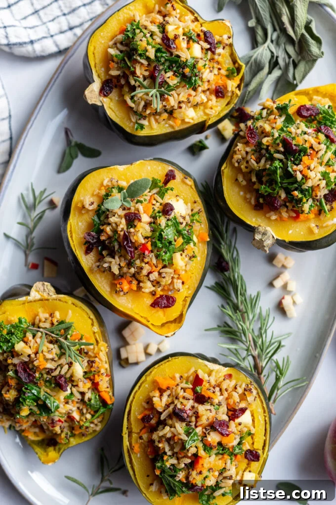 Vegan Acorn Squash Boats 4 cooked vegetarian stuffed acorn squash garnished with fresh herbs and cranberries