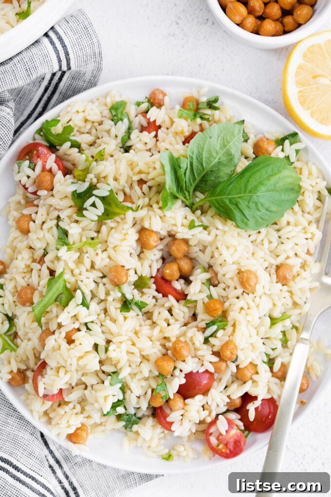 Inspired Chickpea Meals 15 Vibrant Orzo Pasta Salad topped generously with tender chickpeas and juicy cherry tomatoes, a refreshing and complete meal.