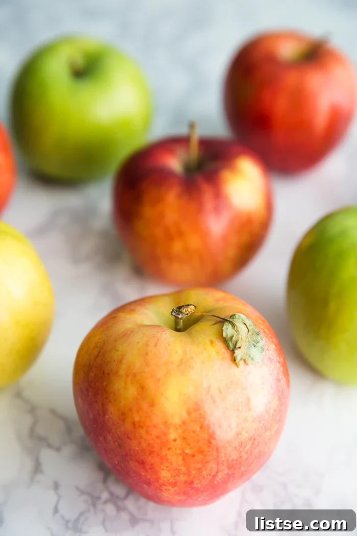 Appetizing A-Foods: A Culinary Exploration 2 red and green apples stacked on a wooden surface