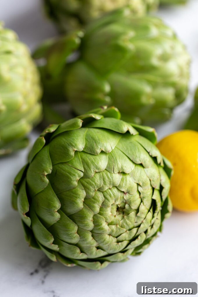 Appetizing A-Foods: A Culinary Exploration 8 fresh artichokes stacked on top of each other