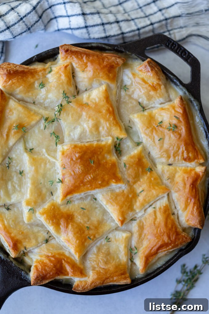 Hearty Chickpea Puff Pastry Pie 4 Hearty chickpea puff pastry pot pie simmering in a cast iron skillet