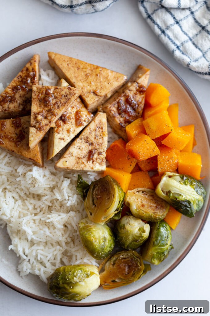 tofu and veggies over rice in a bowl