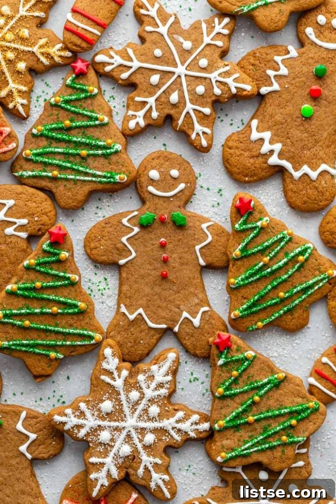 Festive Plant-Based Cookie Delights 2 Festively decorated vegan Christmas cookies with icing and sprinkles on a wooden surface, ready for the holidays