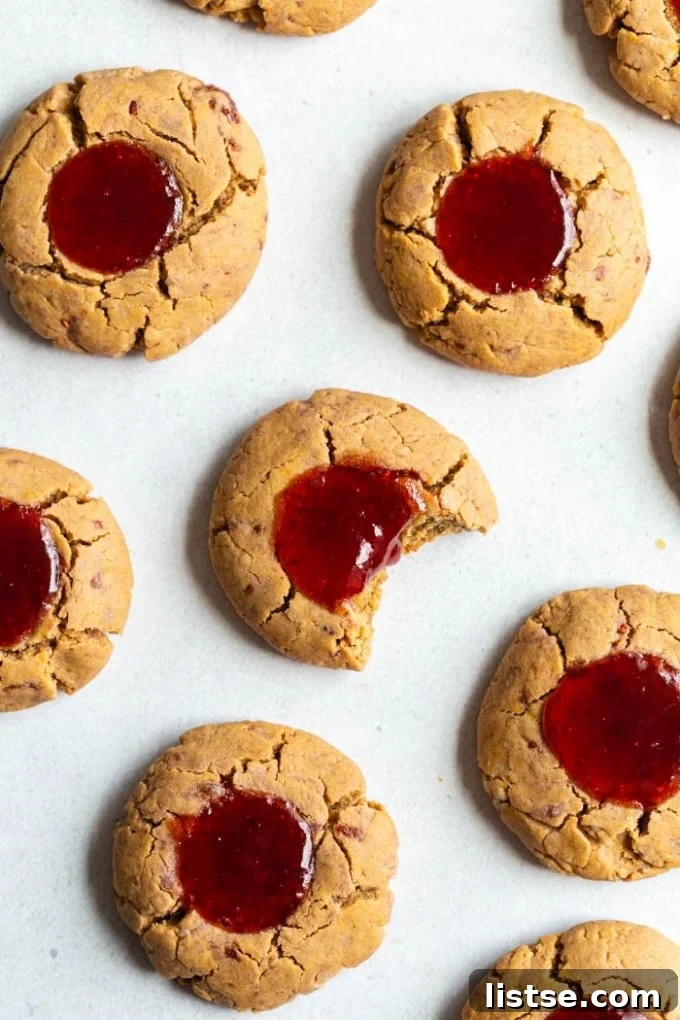 Festive Plant-Based Cookie Delights 14 Assortment of vibrant jam thumbprint cookies with various fruit fillings