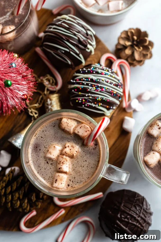 Festive Plant-Based Cookie Delights 15 Cozy cup of hot chocolate with a peppermint stick and marshmallows, surrounded by hot chocolate bombs