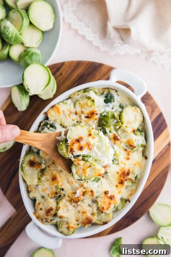Brussels sprouts gratin in a baking dish, bubbling with cheesy topping.