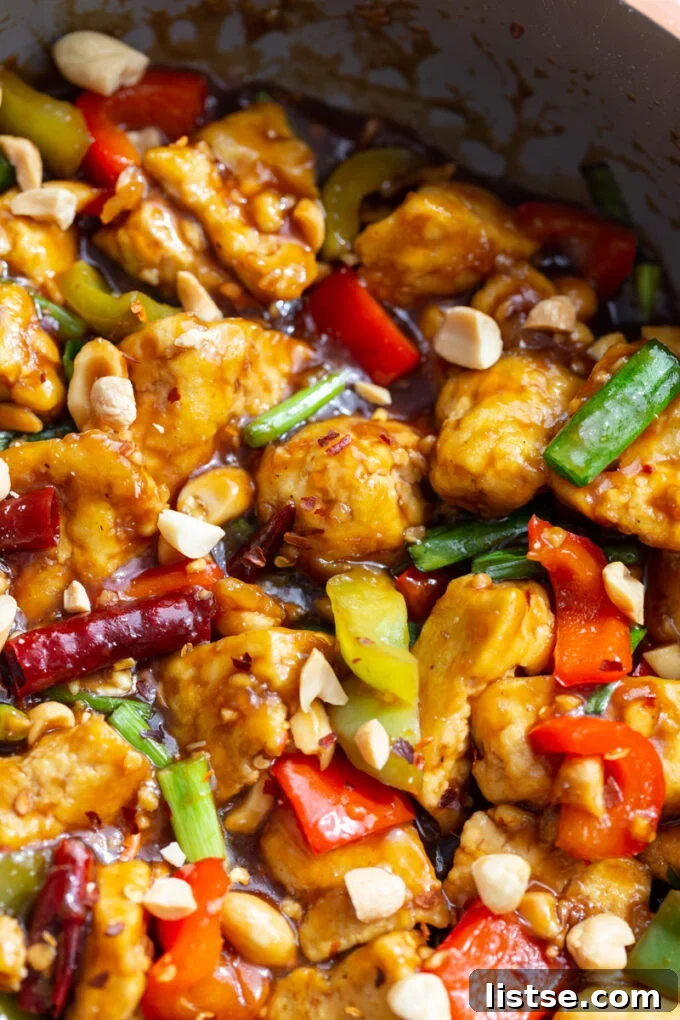 skillet of tofu, bell peppers and dried chilies in a sauce