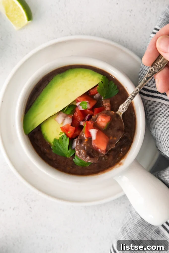 black bean soup topped with avocado and diced to tomatoes