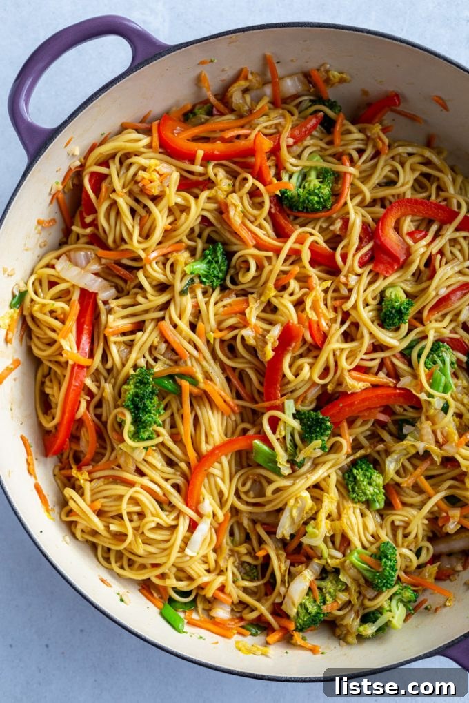 Vegetable Chow Mein cooked in a large skillet, featuring vibrant broccoli florets