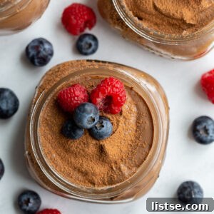 Dreamy Vegan Silken Tofu Chocolate Mousse 8 chocolate vegan pudding in a small glass jar topped with blueberries and raspberries