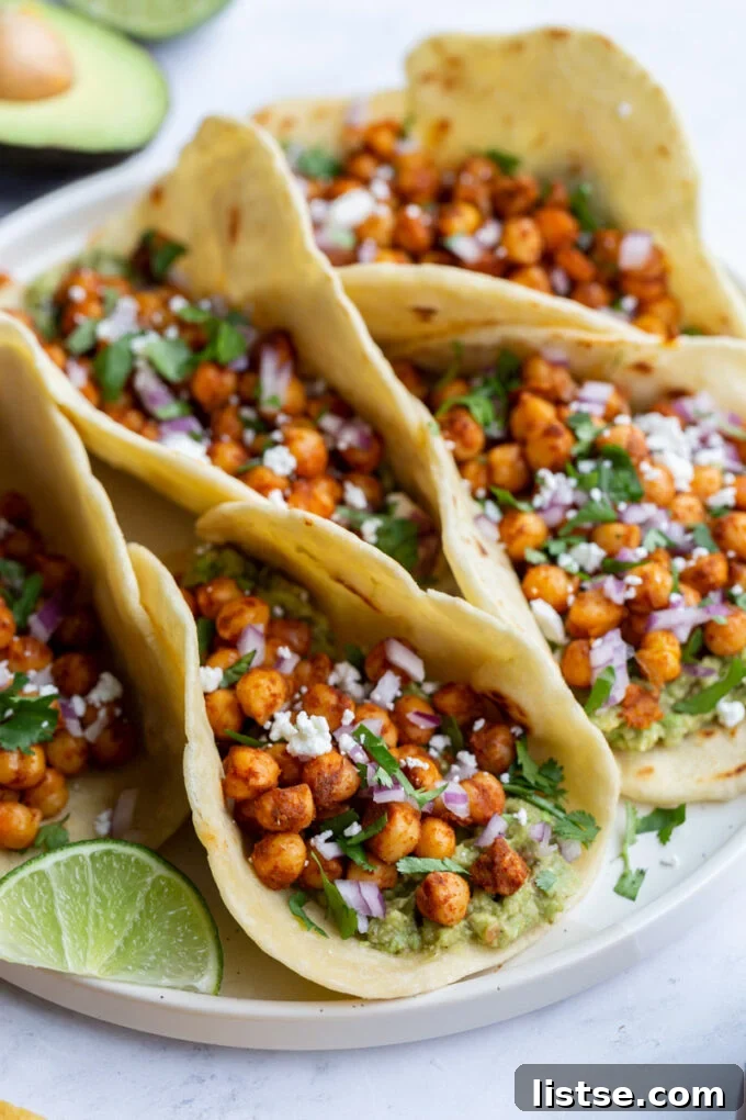 Spiced Chickpea Tacos 3 Close-up of chickpea tacos on a large white plate, garnished with fresh cilantro