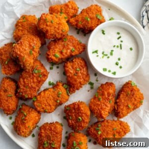 buffalo tempeh served on a large white serving plate with dipping sauce