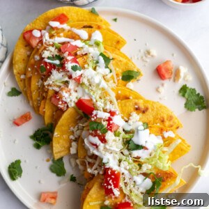 Savory Spud Tacos 7 Potato Tacos topped with cheese on a white plate