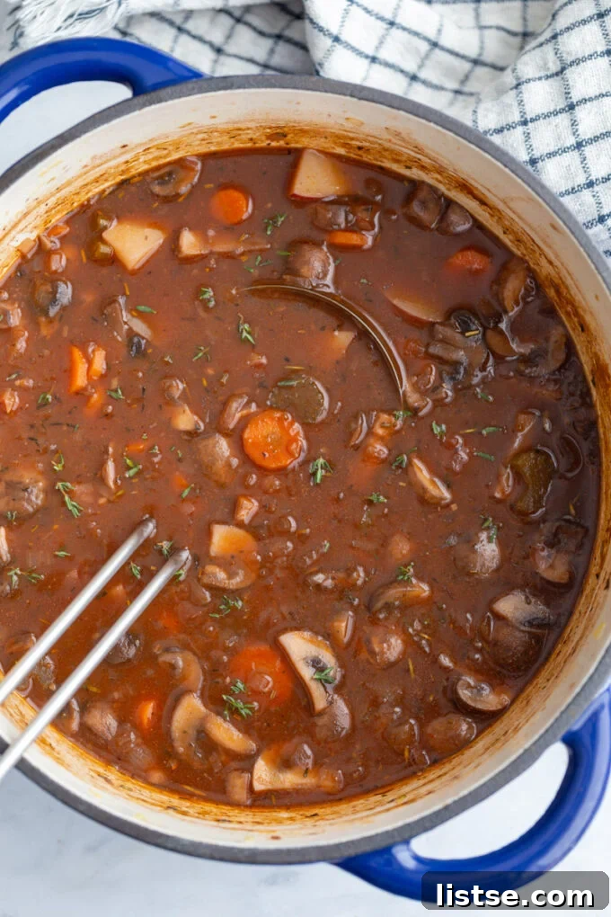 A large pot of vegan stew simmering on the stove