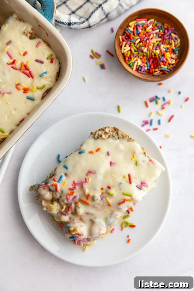 slice of sprinkle baked oats on a small plate with more sprinkles around the scene