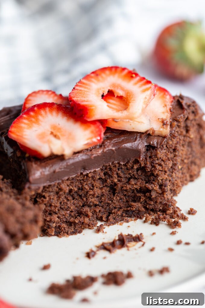Decadent Vegan Gluten-Free Cake 5 A half-eaten slice of vegan gluten-free chocolate cake on a plate, demonstrating its deliciousness.