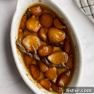 Cooked garlic in a white dish.
