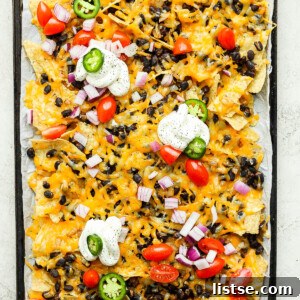 Vegetarian Nachos topped with sour cream, peppers and tomatoes.