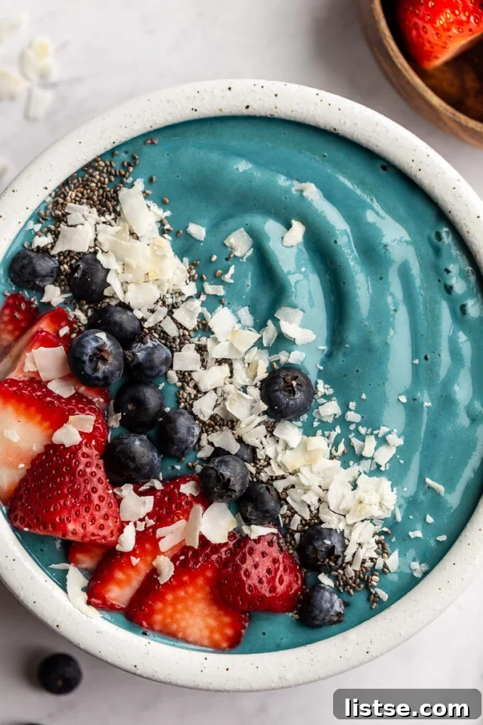 Vibrant Blue Spirulina Smoothie 4 A vibrant Blue Spirulina Smoothie served in a elegant white bowl, showcasing its stunning color.