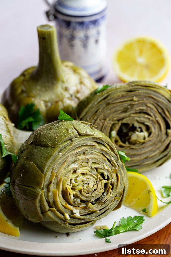 A finished dish of braised Roman Artichokes, garnished simply with olive oil and herbs