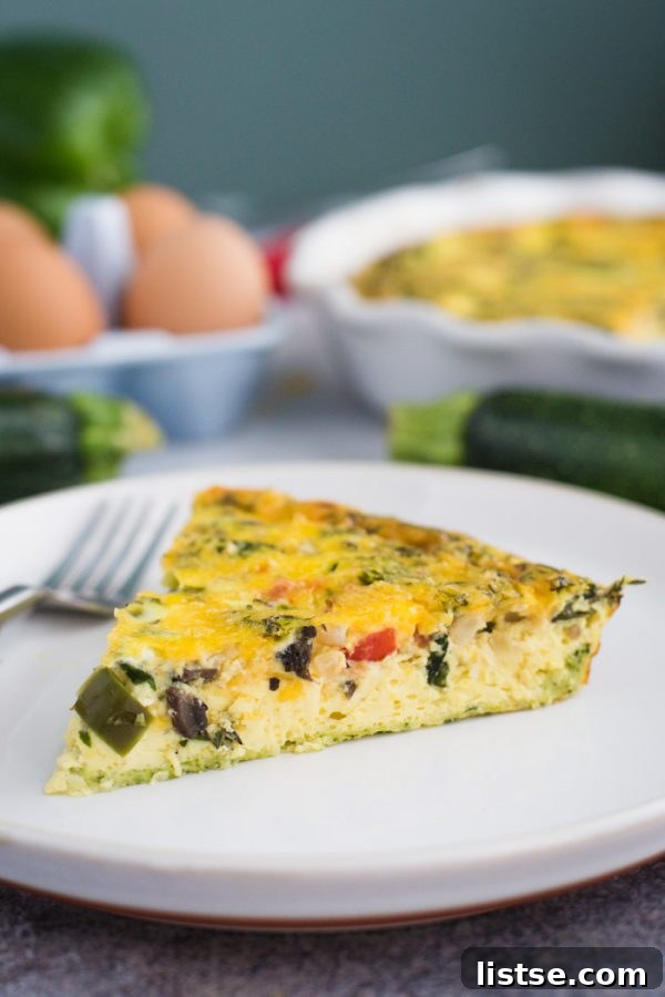A slice of healthy Zucchini Crust Quiche ready to be enjoyed.