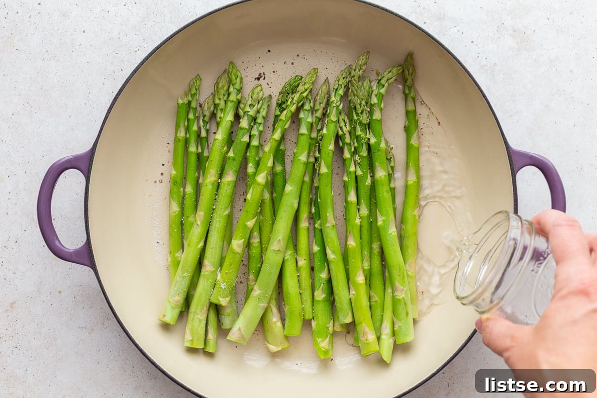 Speedy Skillet Asparagus 6 asparagus in a large skillet with water being poured in