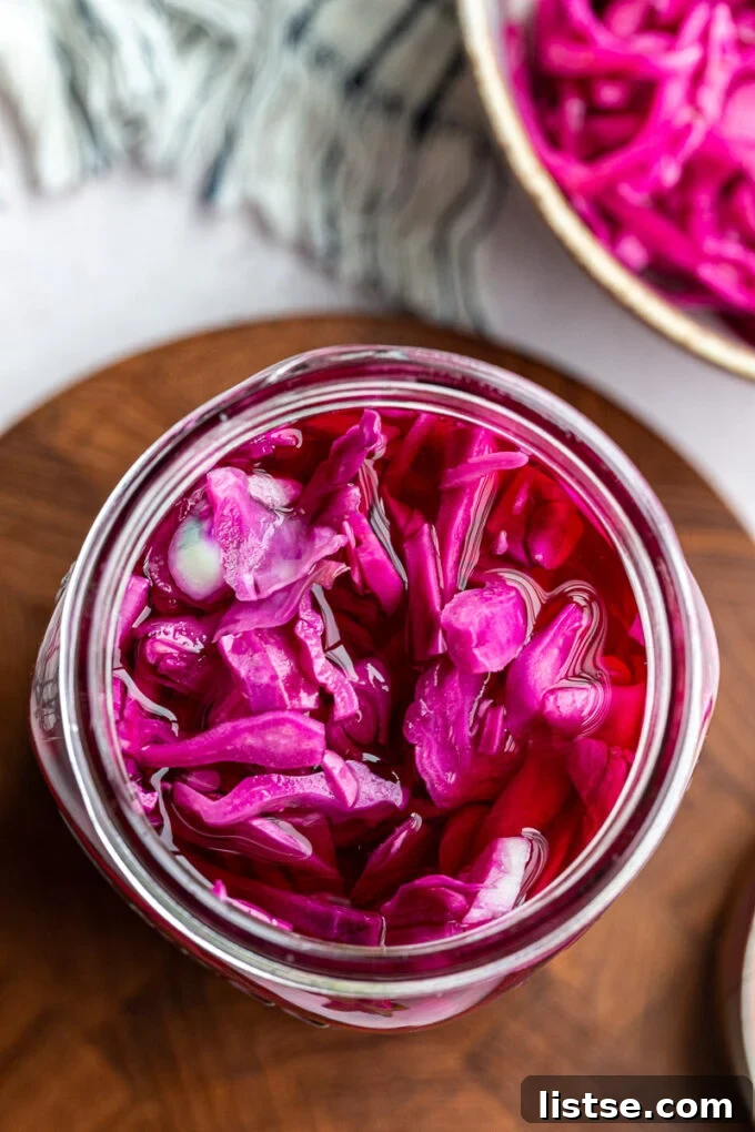 Pickled red cabbage mixed with brine in a mason jar.