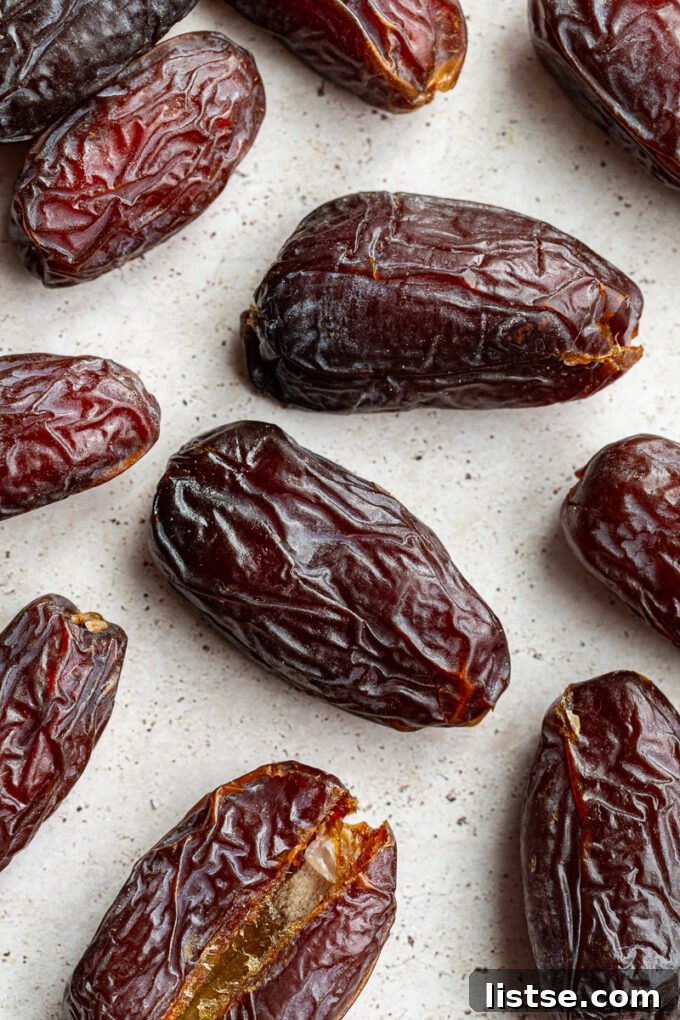 Fresh Medjool dates arranged beautifully in a bowl, showcasing their plump and wrinkly texture