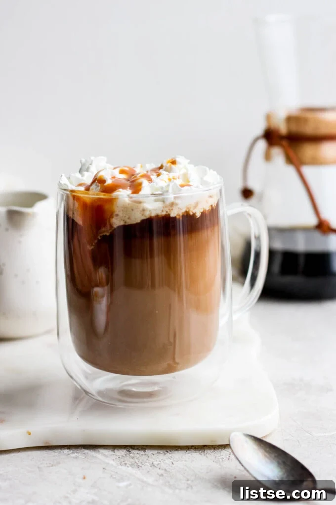 Velvet Caramel Dream 2 Caramel latte topped with whipped cream and caramel drizzle, ready to be enjoyed.