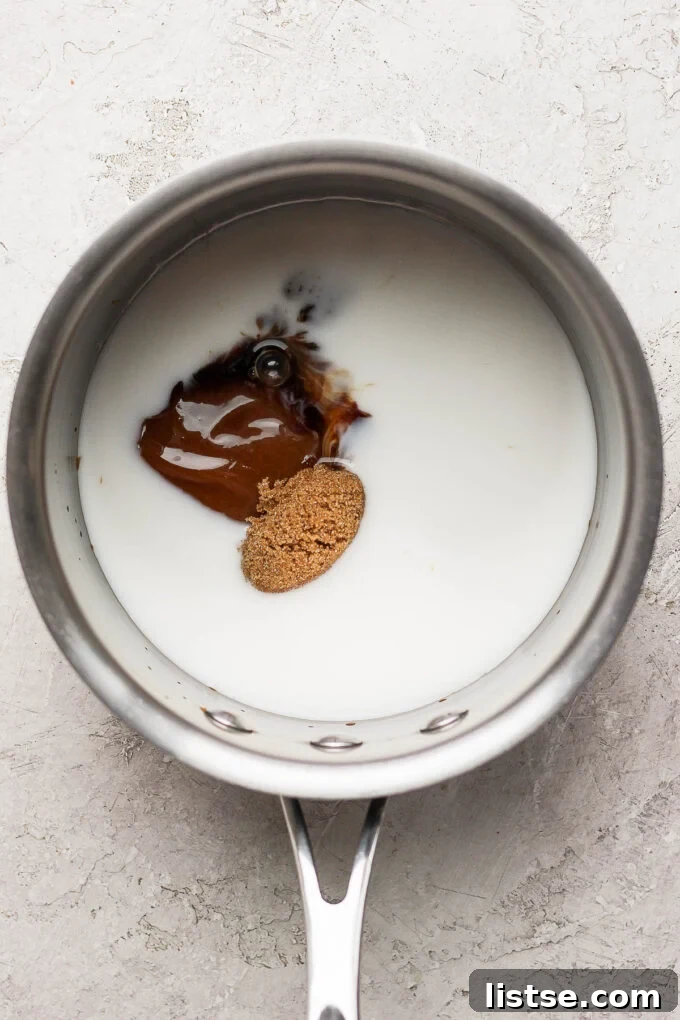 Velvet Caramel Dream 4 A small saucepan containing milk, brown sugar, and caramel sauce, ready to be heated.