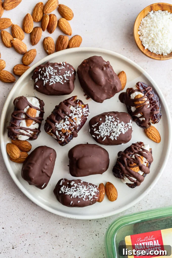 Close-up of Almond Joy stuffed Medjool dates, showcasing the rich chocolate coating and a single almond on top.