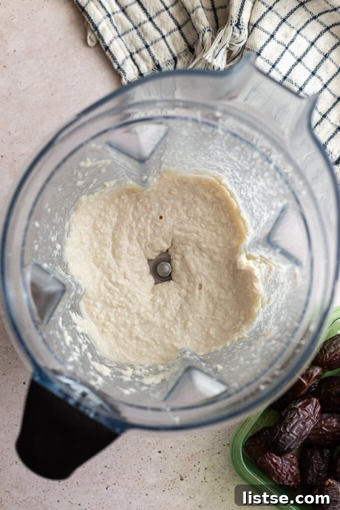 Coconut, coconut cream, and maple syrup blended together in a food processor, ready for stuffing.