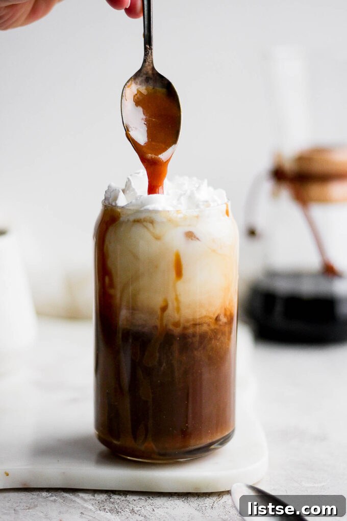 Adding caramel drizzle to a iced latte.