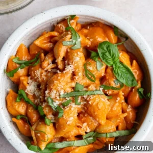 Pasta shells with sauce and topped with fresh basil.